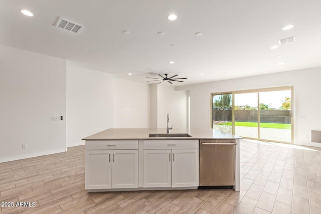 kitchen with visible vents, wood finish floors, stainless steel dishwasher, a sink, and recessed lighting