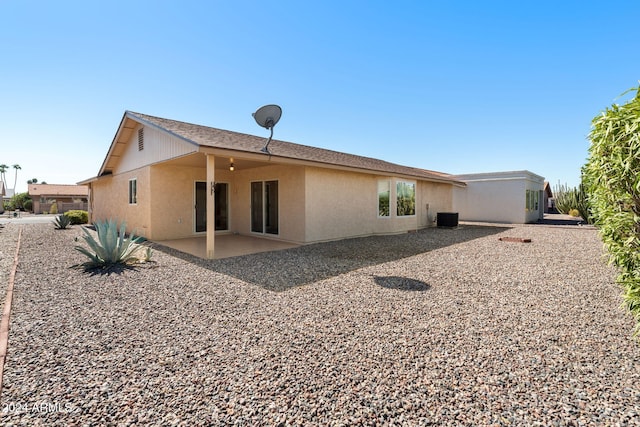 rear view of house with central AC and a patio