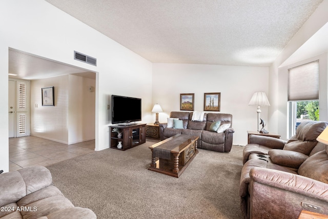 carpeted living room featuring vaulted ceiling and a textured ceiling