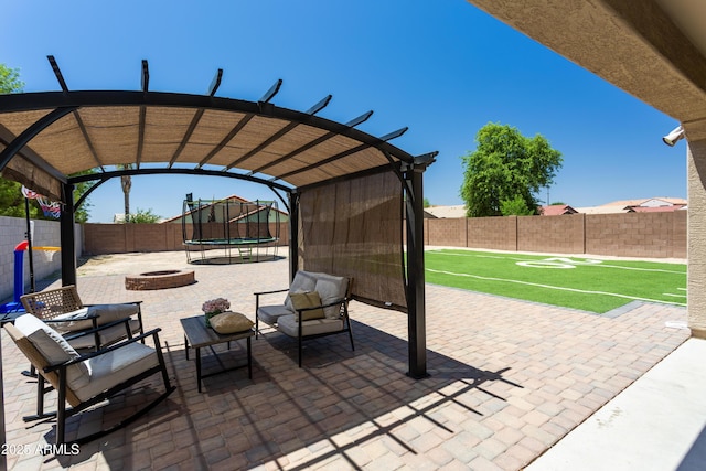 18575 W Vogel Ave, Goodyear, AZ 85338 - fenced backyard with a trampoline, a patio area, a fire pit, and a pergola
