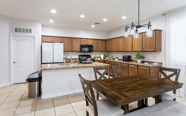 18575 W Vogel Ave, Goodyear, AZ 85338 - kitchen with black appliances, a sink, brown cabinets, a kitchen island with sink, and recessed lighting