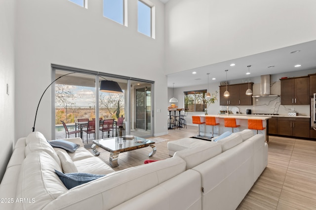 living room featuring light tile patterned floors, plenty of natural light, and baseboards