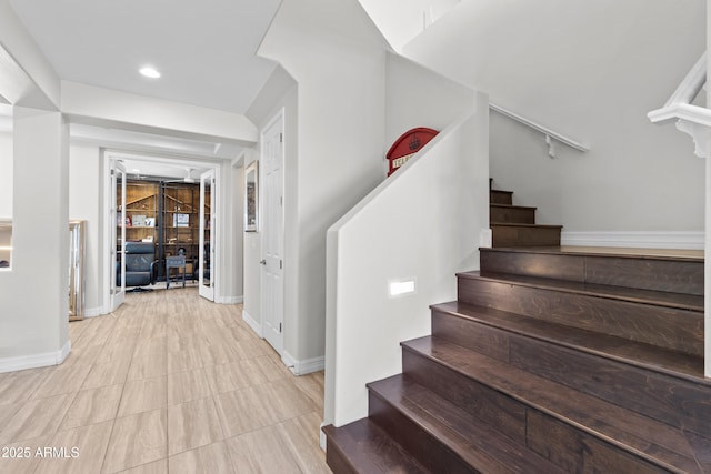 staircase with recessed lighting and baseboards