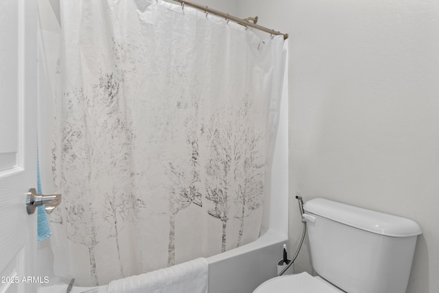 bathroom with toilet and shower / tub combo with curtain