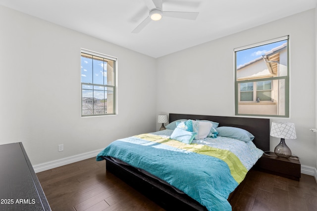 bedroom with wood-type flooring, a ceiling fan, and baseboards