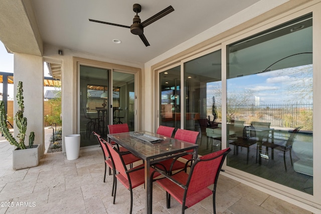 view of patio / terrace with outdoor dining space, fence, and a ceiling fan