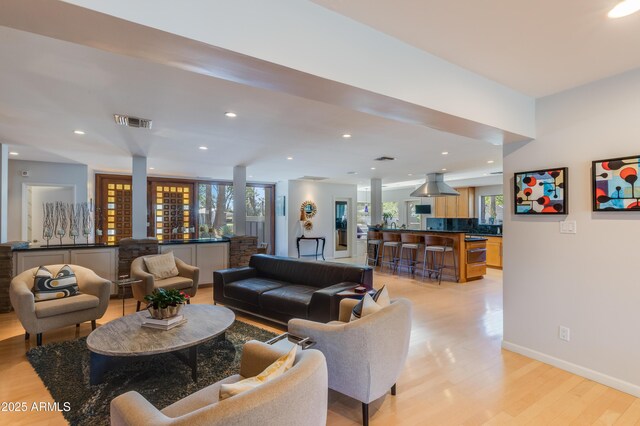 345 W Gardenia Dr, Phoenix, AZ 85021 - living area with light wood-style flooring, visible vents, baseboards, recessed lighting, and a dry bar