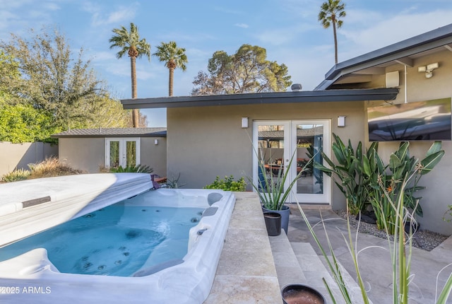 345 W Gardenia Dr, Phoenix, AZ 85021 - back of property with stucco siding, french doors, and a hot tub