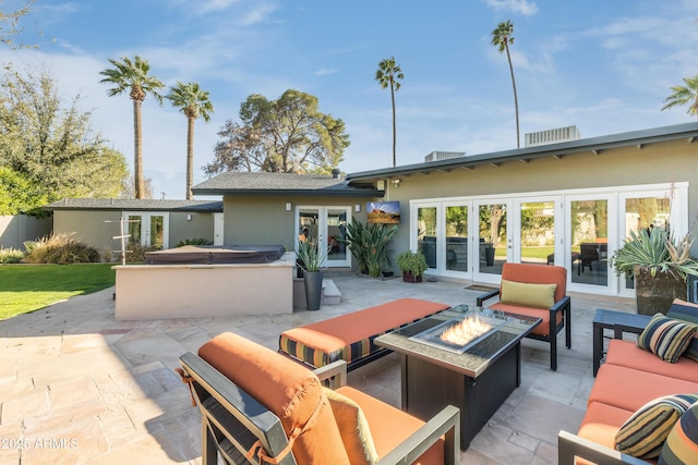 345 W Gardenia Dr, Phoenix, AZ 85021 - exterior space with stucco siding, a patio, french doors, and an outdoor living space with a fire pit