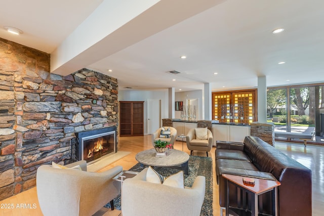 345 W Gardenia Dr, Phoenix, AZ 85021 - living area featuring a stone fireplace, visible vents, wood finished floors, and recessed lighting