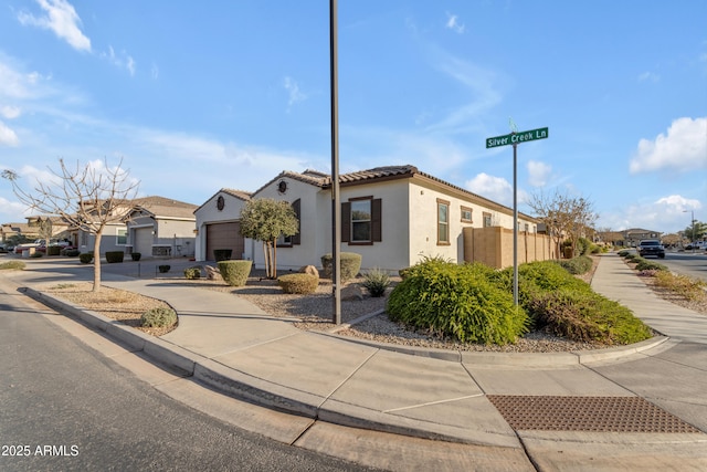 22837 E Silver Creek Ln, Queen Creek, AZ 85142 - view of front of property featuring concrete driveway, a residential view, a tiled roof, an attached garage, and stucco siding