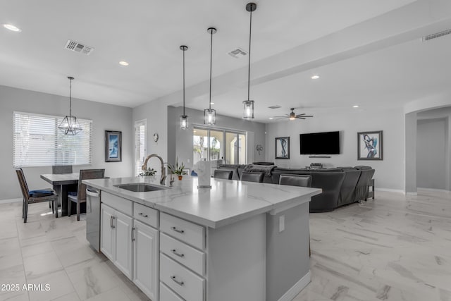 22837 E Silver Creek Ln, Queen Creek, AZ 85142 - kitchen featuring white cabinets, an island with sink, open floor plan, marble finish floor, and light stone countertops
