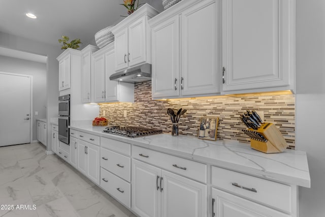 22837 E Silver Creek Ln, Queen Creek, AZ 85142 - kitchen with under cabinet range hood, appliances with stainless steel finishes, white cabinets, and marble finish floor