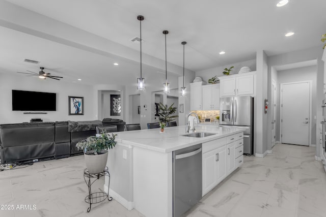 22837 E Silver Creek Ln, Queen Creek, AZ 85142 - kitchen with appliances with stainless steel finishes, open floor plan, white cabinetry, a sink, and an island with sink