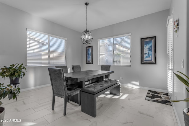 22837 E Silver Creek Ln, Queen Creek, AZ 85142 - dining area featuring a notable chandelier, marble finish floor, and baseboards