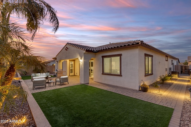22837 E Silver Creek Ln, Queen Creek, AZ 85142 - rear view of house featuring a lawn, a patio, a tile roof, an outdoor hangout area, and stucco siding