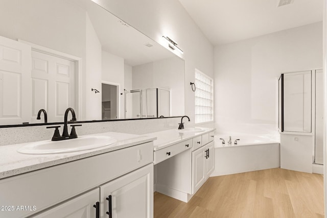 1112 E Winged Foot Dr, Chandler, AZ 85249 - full bathroom featuring a stall shower, double vanity, wood finished floors, and a sink