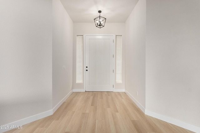 1112 E Winged Foot Dr, Chandler, AZ 85249 - interior space featuring baseboards, light wood-style flooring, and an inviting chandelier