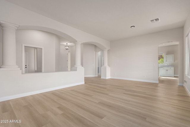 1112 E Winged Foot Dr, Chandler, AZ 85249 - spare room with visible vents, light wood finished floors, ornate columns, baseboards, and arched walkways