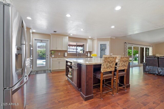 1670 E Whitten St, Chandler, AZ 85225 - kitchen with stainless steel fridge, a center island, open floor plan, dark wood-type flooring, and recessed lighting