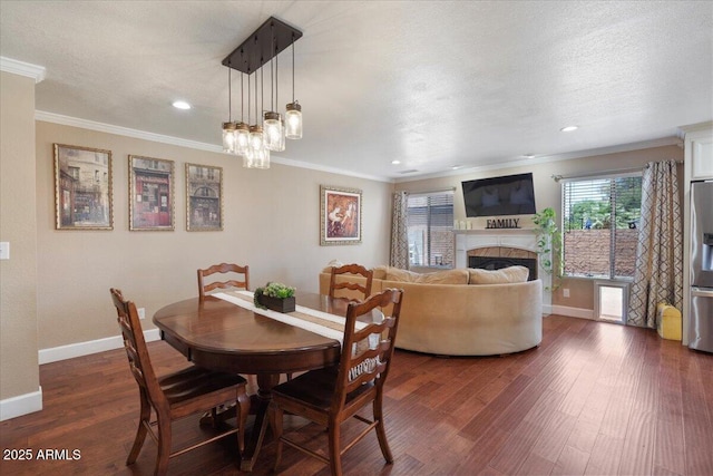 1670 E Whitten St, Chandler, AZ 85225 - dining space featuring crown molding, dark wood-style floors, baseboards, a fireplace, and recessed lighting