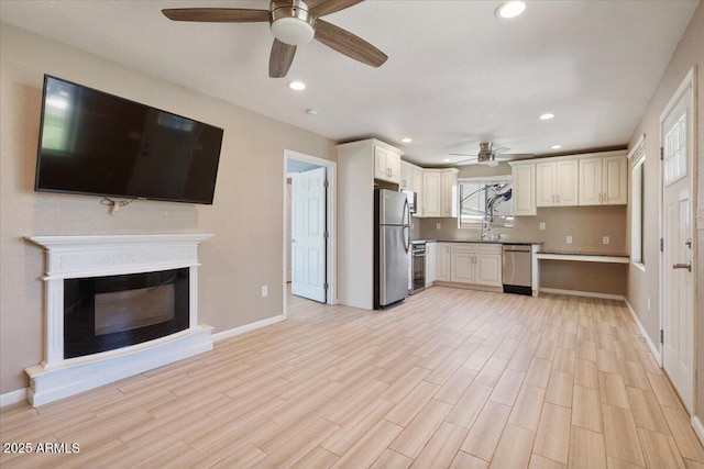 1670 E Whitten St, Chandler, AZ 85225 - kitchen featuring a ceiling fan, appliances with stainless steel finishes, light wood-style floors, a sink, and baseboards