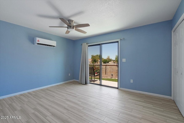 1670 E Whitten St, Chandler, AZ 85225 - spare room with a wall mounted air conditioner, ceiling fan, baseboards, and light wood-style floors