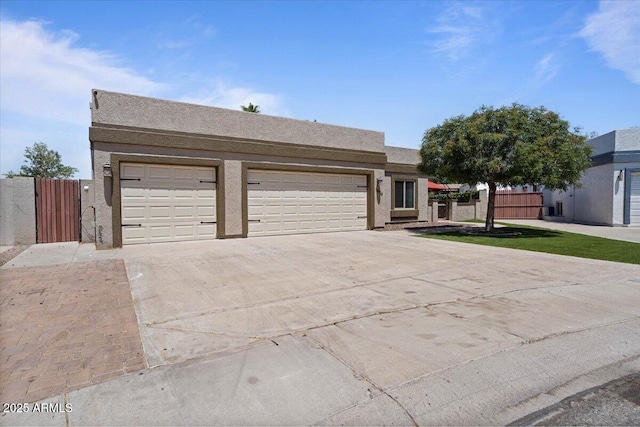 1670 E Whitten St, Chandler, AZ 85225 - view of front of home featuring driveway, an attached garage, stucco siding, and a gate