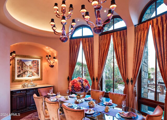 dining space featuring a wealth of natural light and a notable chandelier