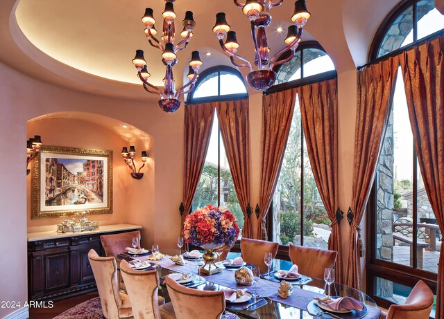 9808 E Honey Mesquite Dr, Scottsdale, AZ 85262 - dining area featuring a chandelier, arched walkways, and a high ceiling