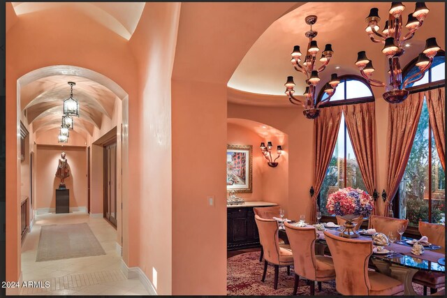 dining area featuring light tile patterned floors and a notable chandelier