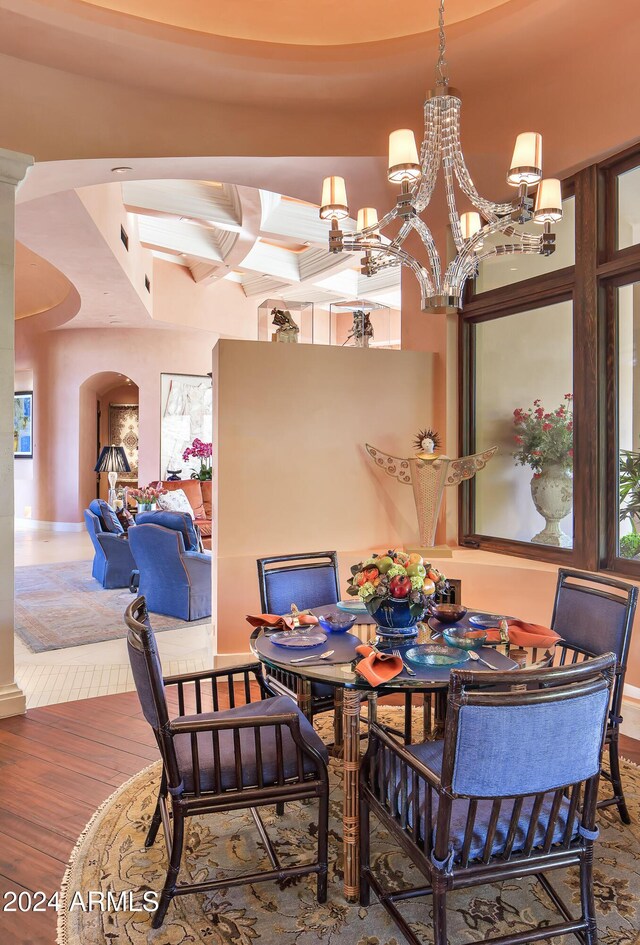 9808 E Honey Mesquite Dr, Scottsdale, AZ 85262 - dining area with coffered ceiling, a chandelier, wood finished floors, arched walkways, and beam ceiling