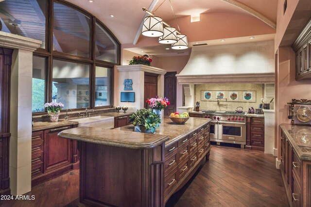 9808 E Honey Mesquite Dr, Scottsdale, AZ 85262 - kitchen with double oven range, a sink, dark wood finished floors, a kitchen island, and a high ceiling
