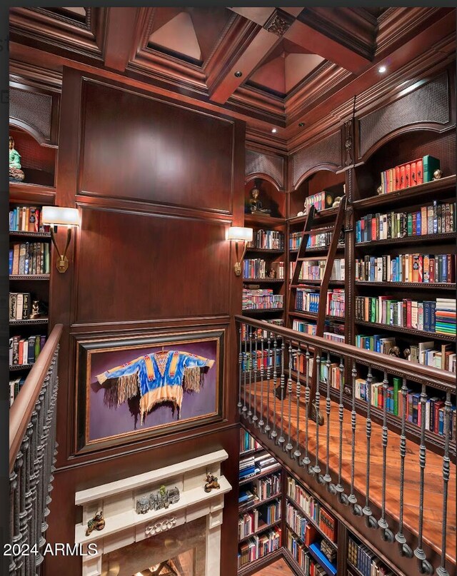 details featuring built in shelves, wood walls, and ornamental molding