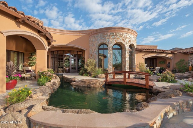 9808 E Honey Mesquite Dr, Scottsdale, AZ 85262 - view of swimming pool featuring a garden pond, a patio, and french doors