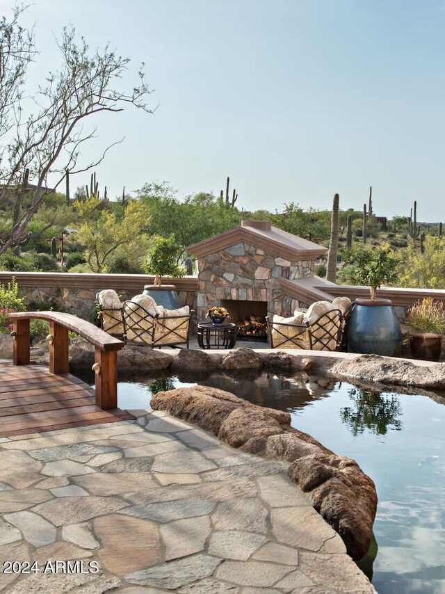 exterior space featuring an outdoor stone fireplace