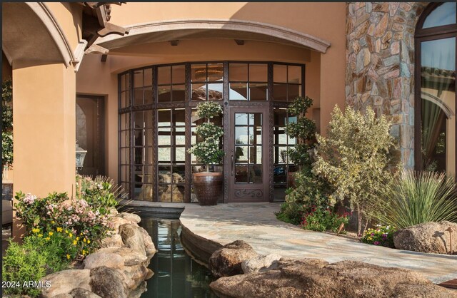 9808 E Honey Mesquite Dr, Scottsdale, AZ 85262 - view of exterior entry featuring french doors, stucco siding, and stone siding