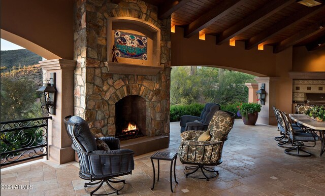 view of patio with an outdoor stone fireplace