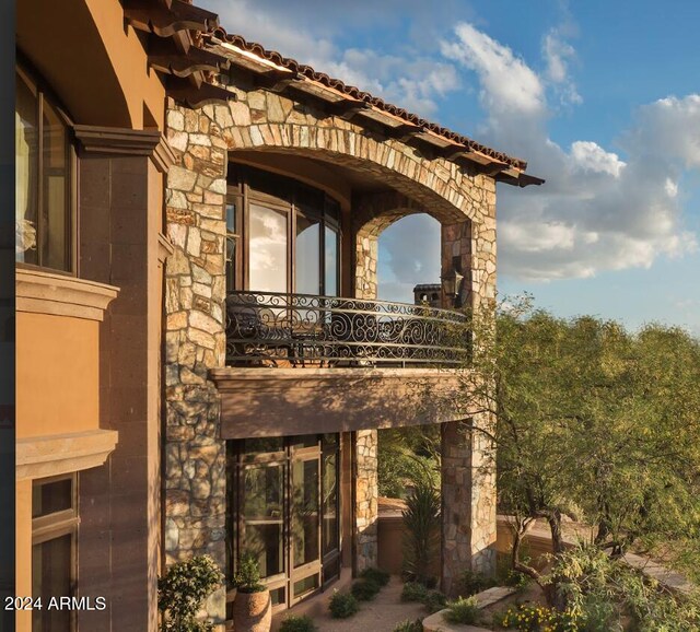 9808 E Honey Mesquite Dr, Scottsdale, AZ 85262 - back of house featuring stone siding and a balcony