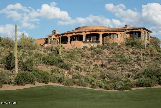 9808 E Honey Mesquite Dr, Scottsdale, AZ 85262 - back of property featuring a tiled roof, a chimney, view of golf course, and a yard