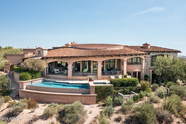 9808 E Honey Mesquite Dr, Scottsdale, AZ 85262 - back of house with a chimney, an in-ground hot tub, a tile roof, stucco siding, and a patio area