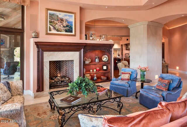 9808 E Honey Mesquite Dr, Scottsdale, AZ 85262 - tiled living room featuring arched walkways, decorative columns, a high end fireplace, and recessed lighting