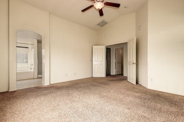 unfurnished bedroom with carpet flooring, ceiling fan, lofted ceiling, and connected bathroom