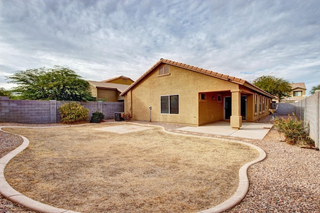 back of house featuring central AC and a patio