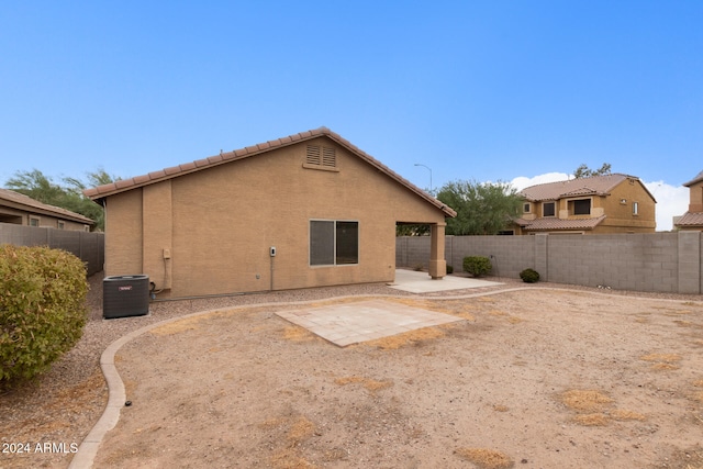 back of house featuring a patio area and central air condition unit