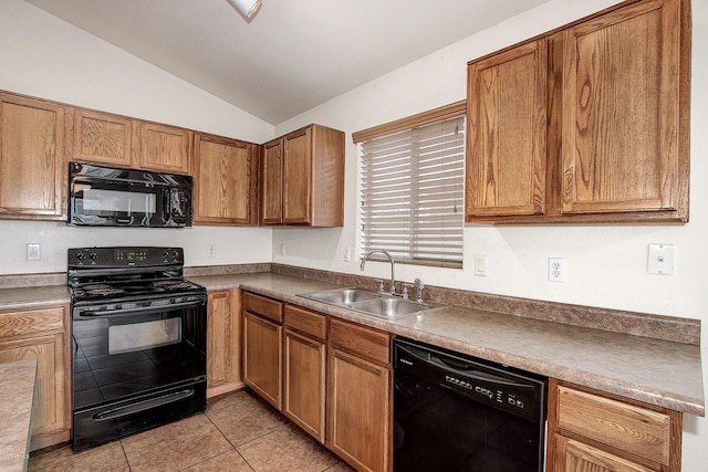 kitchen with black appliances, lofted ceiling, sink, and light tile patterned floors