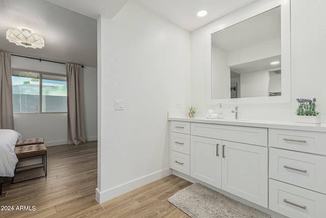 bathroom with vanity and hardwood / wood-style flooring