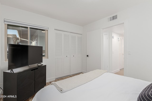 bedroom featuring light hardwood / wood-style flooring, access to exterior, and a closet