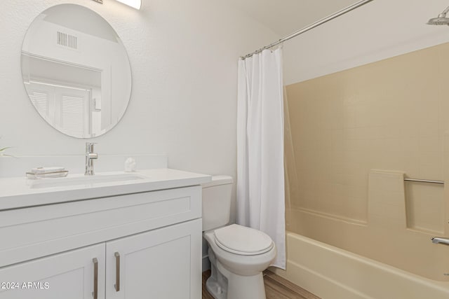 full bathroom with vanity, toilet, shower / bath combo, and hardwood / wood-style floors