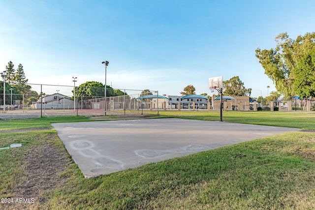 view of sport court featuring a lawn